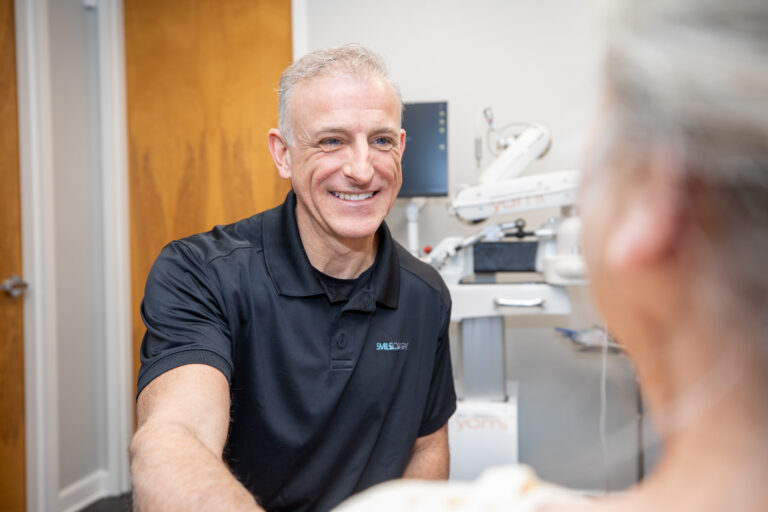 Niceville dentist Dr. Broutin consulting a patient on gum disease treatment