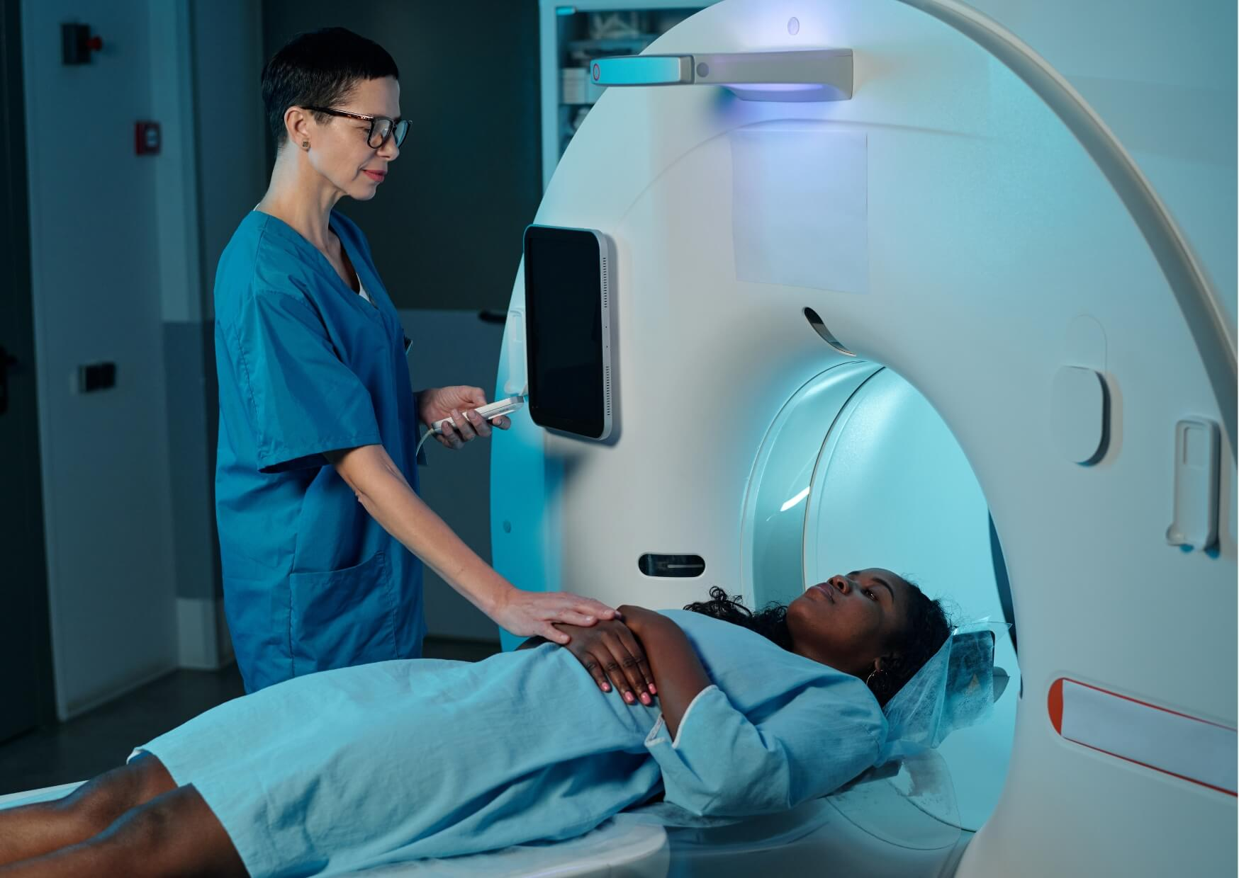 Patient undergoing an MRI scan while discussing the safety of having an MRI with dental implants.