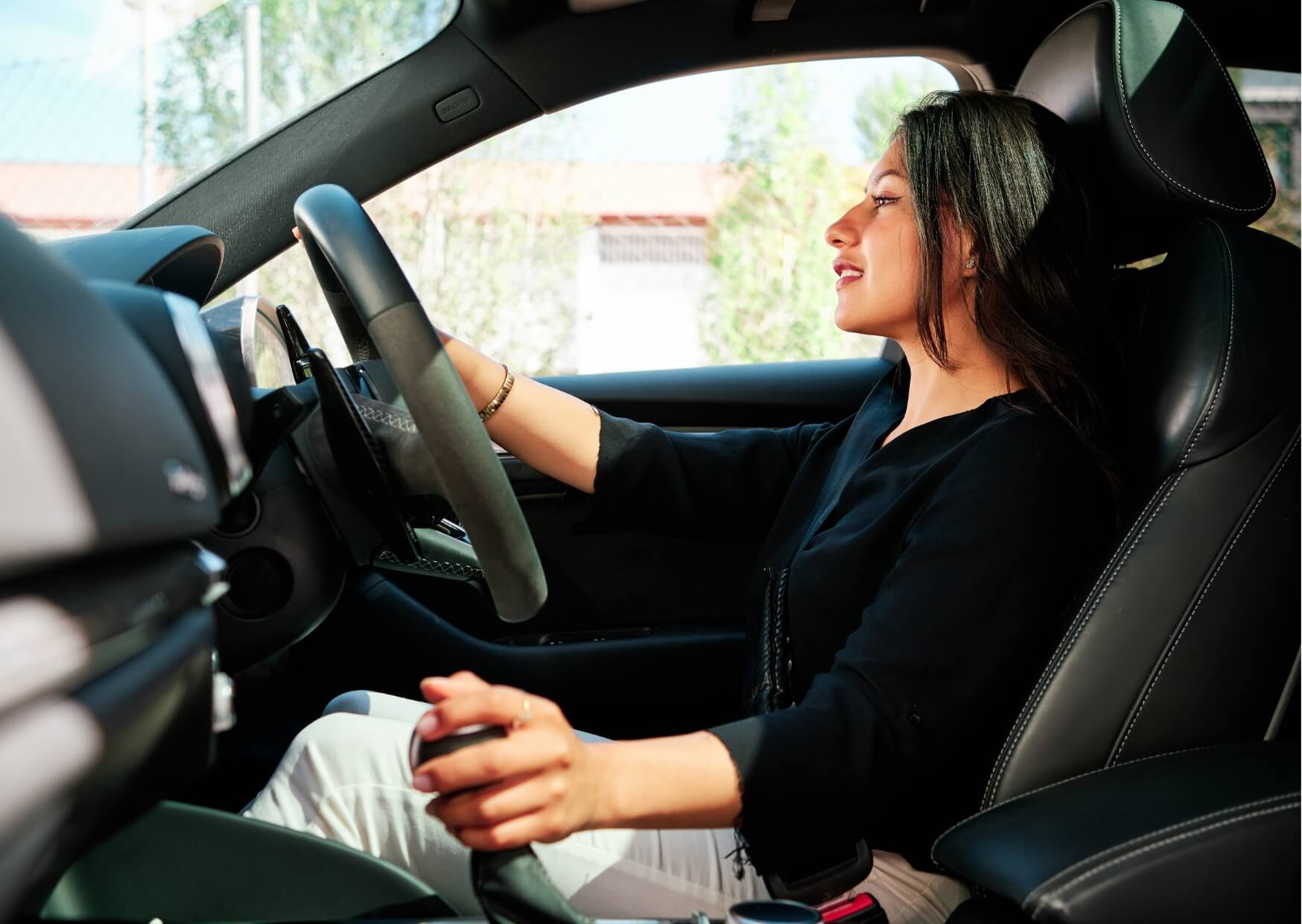 Woman driving a car comfortably after a dental procedure, illustrating when driving after root canal treatment may be appropriate.