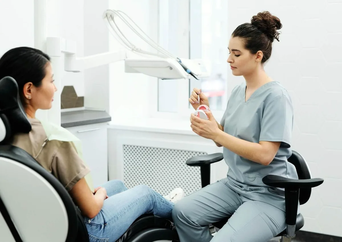 Dental professional explaining post-surgery care and soft foods to eat after dental implant surgery.